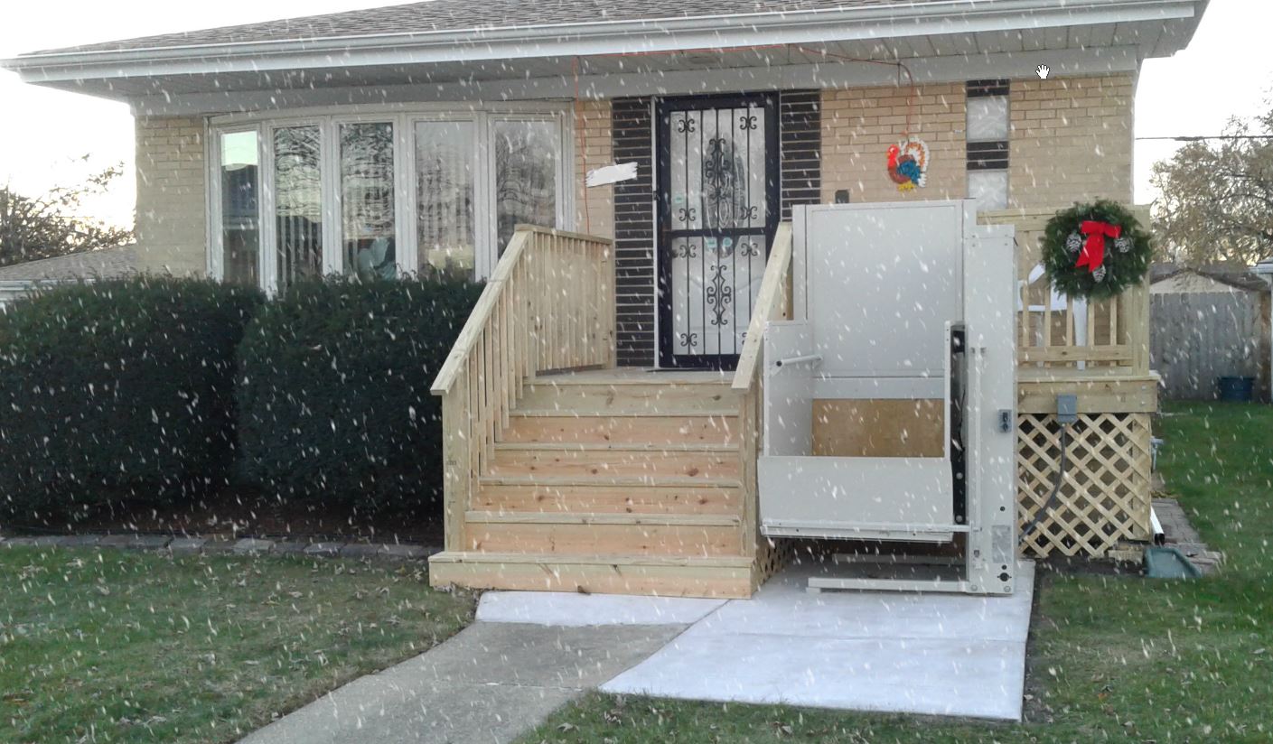 outdoor wheelchair lift installed while it's snowing in suburb near Chicago