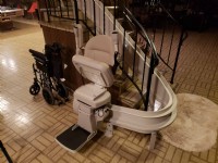Bruno Elite curved rail stairlift folded at bottom of stairs in Wilmette home