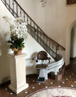 Bruno Elite curved stairlift with brown upholstery installed in home in Los Angeles