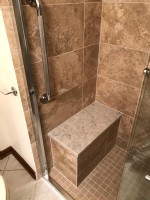 beautiful shower with built in bench and grab bars