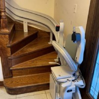 curved stairlift at bottom landing of stairs in Darien IL home by Lifeway Mobility