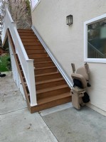 outdoor stairlift in Los Angeles with components folded up at bottom landing
