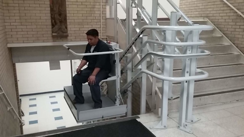 Man riding inclined platform lift installed by Lifeway Chicagoland
