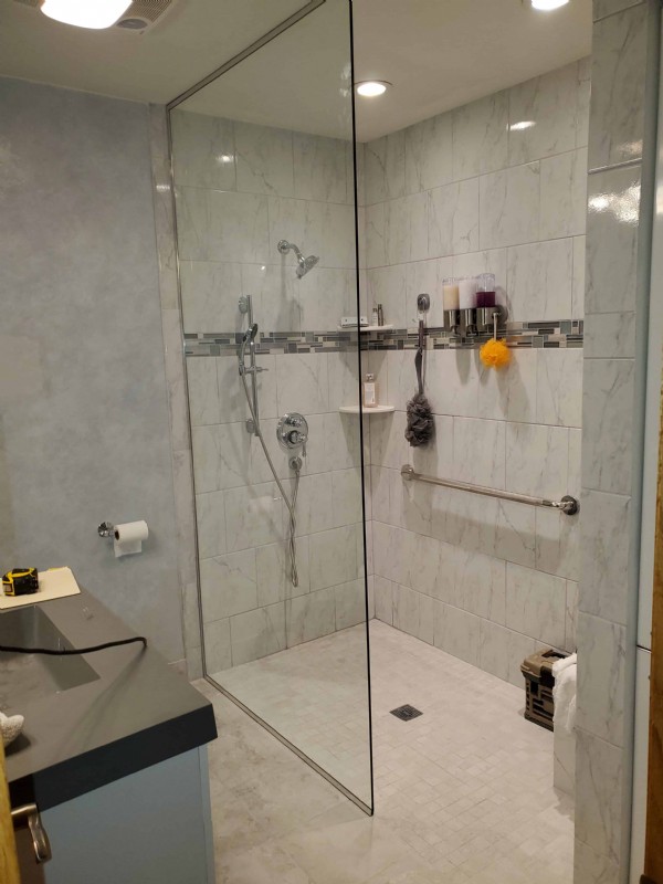 wheelchair-accessible-shower-with-grab-bar-and-glass-shower-door-in-Wheeling-Illinois.jpg