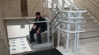 Man riding inclined platform lift installed by Lifeway Chicagoland