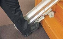 Image of a man's foot on the folding rail's foot lock