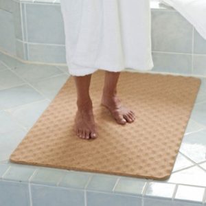 Image of a senior standing on a slip-resistant bathroom floor mat